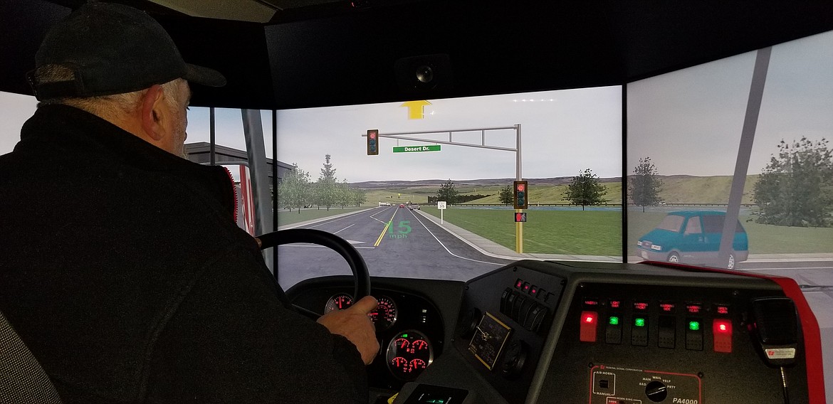 Photo by MANDI BATEMAN
Paradise Valley Fire Chief Mike Glazier navigates traffic in the state of the art emergency vehicle driving simulator trailer that was brought to Boundary County in April for training.