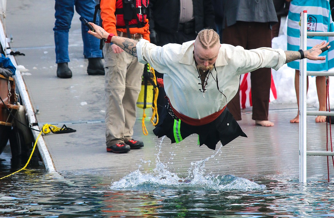 Photo by MANDI BATEMAN
North Bench firefighter, Tom Chaney, takes flight before a belly flop at the 2019 Penguin Plunge,