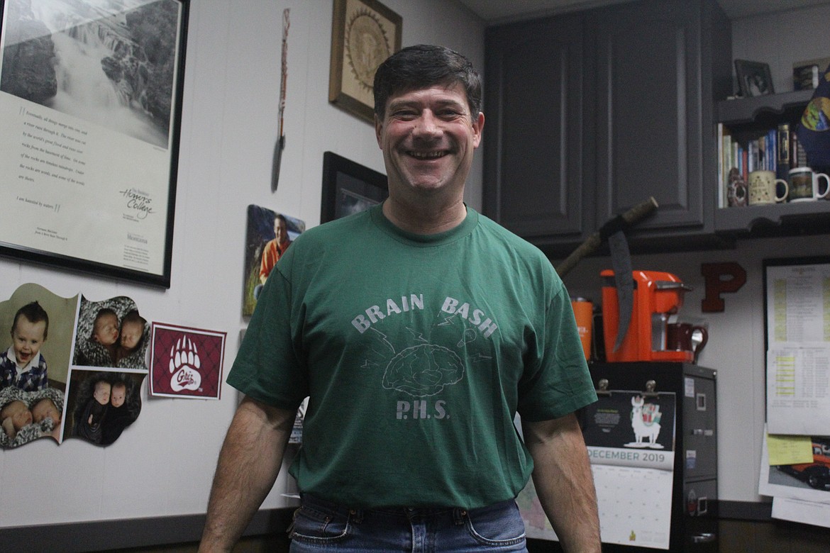 THOM CHISHOLM, the Plains Schools Superintendent, displays one of the original Brain Bash shirts from 1996. (John Dowd/Clark Fork Valley Press)