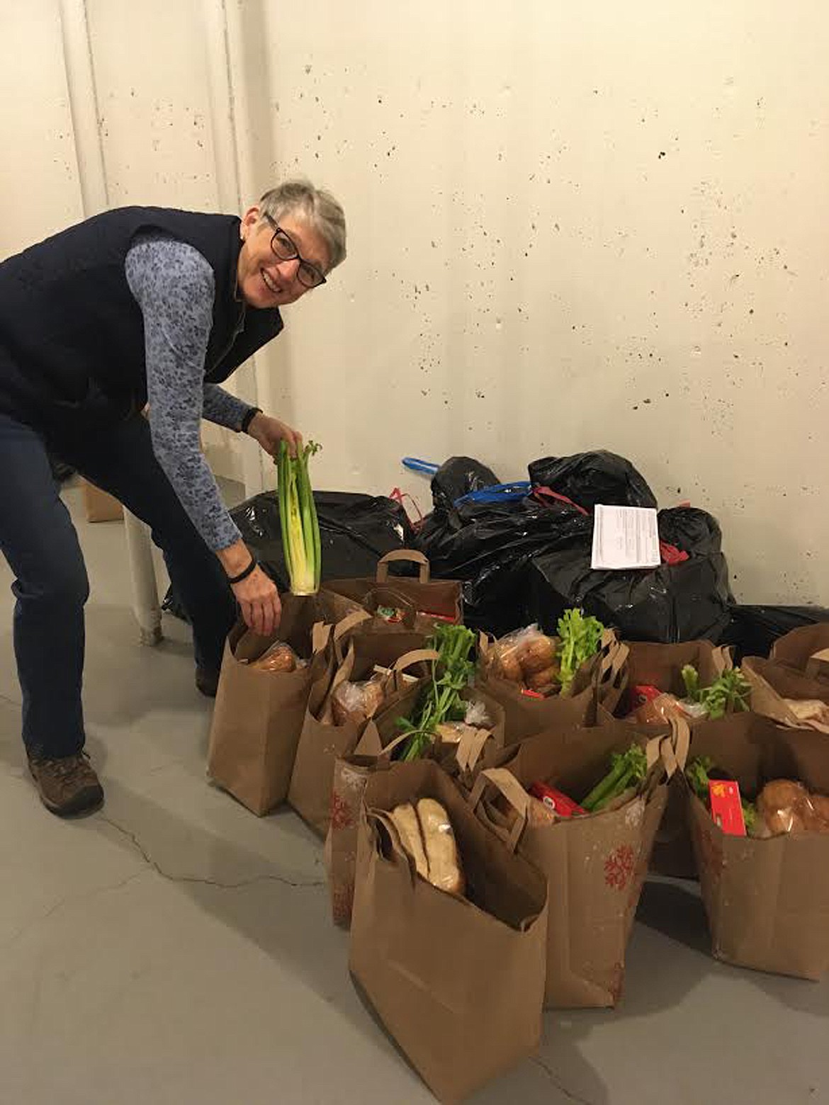 Debbie Rolleri of the Sanders County Sheriff&#146;s Office helps pack all the fixings for holiday dinners, from turkey, potatoes, and stuffing right down to the yams and butter. (Carolyn Hidy/Valley Press)