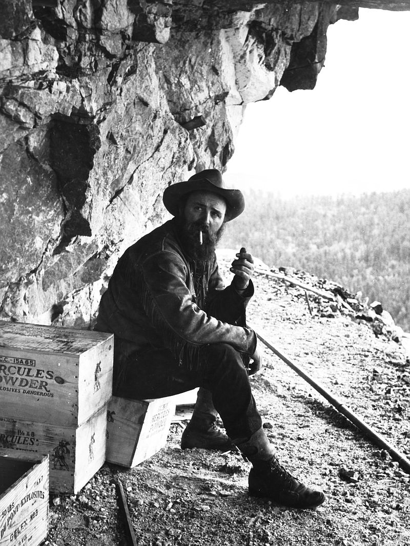 NPR
Crazy Horse Memorial Sculptor Korczak Ziolkowski began the project in 1948, shown here smoking a cigarette near a crate of dynamite on a bluff in Black Hills, S.D., in 1950.