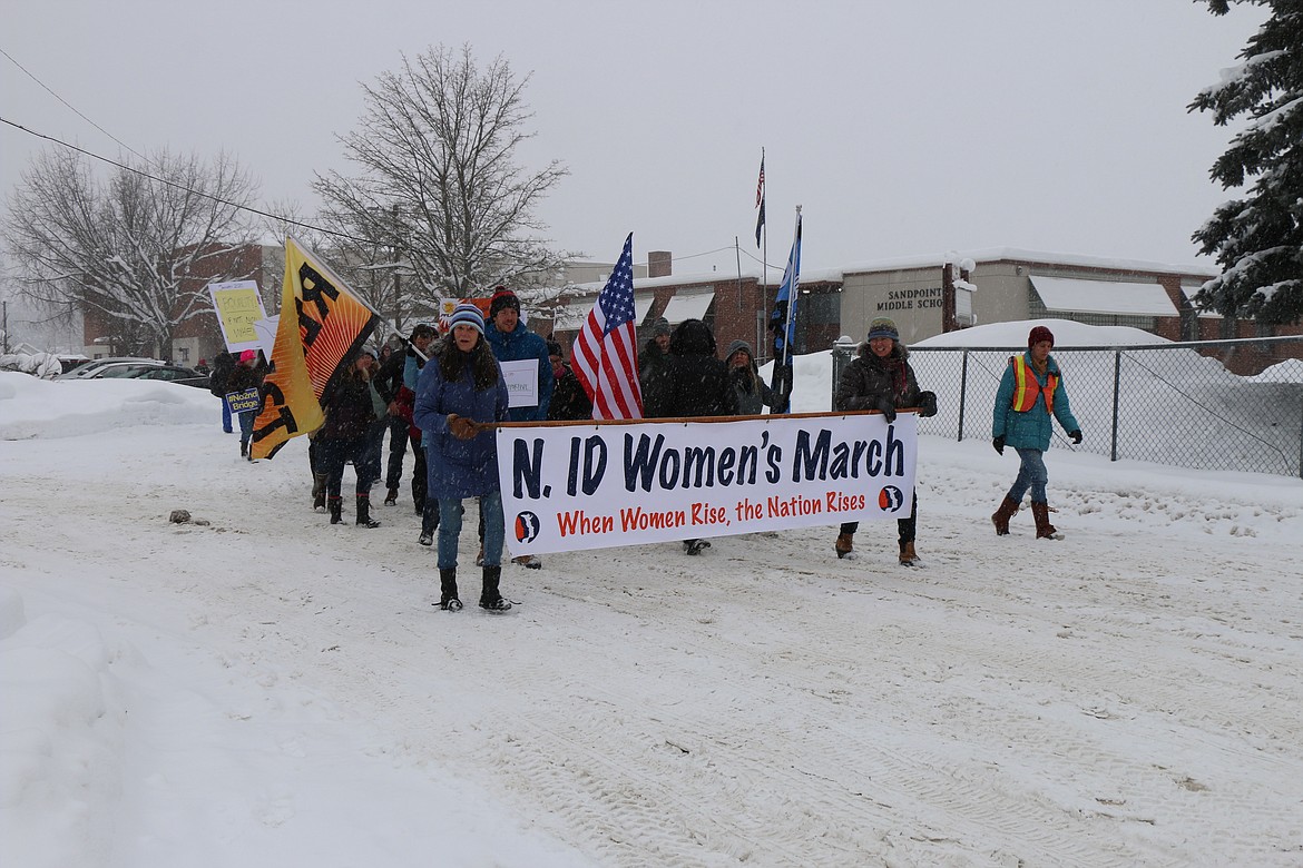 (Photo by CAROLINE LOBSINGER)
A few of the participants at the N. Idaho Women&#146;s March brave the cold and snow to march through the streets call attention to women&#146;s rights, human rights and social justice.