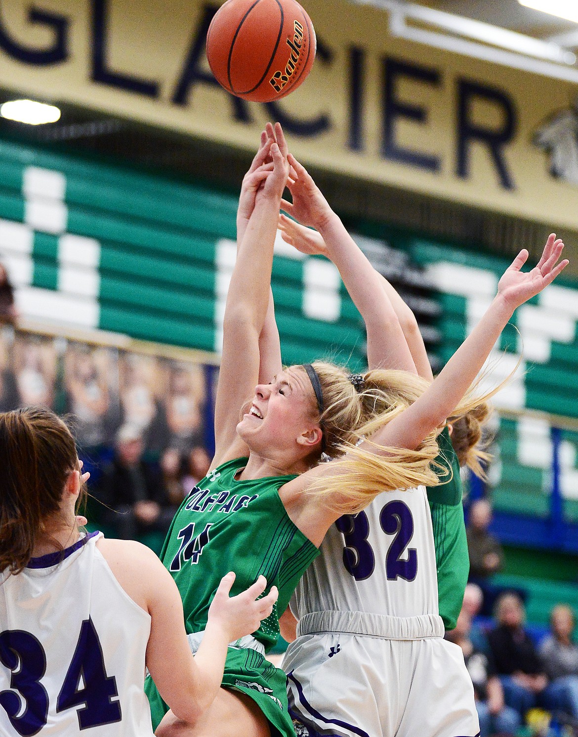 Glacier's Aubrie Rademacher (14) reaches for a rebound against Butte at Glacier High School on Saturday. (Casey Kreider/Daily Inter Lake)