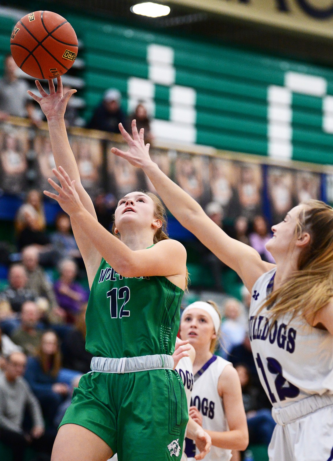 Glacier's Kenzie Williams (12) drives to the hoop against Butte's Makenna Carpenter (12) at Glacier High School on Saturday. (Casey Kreider/Daily Inter Lake)