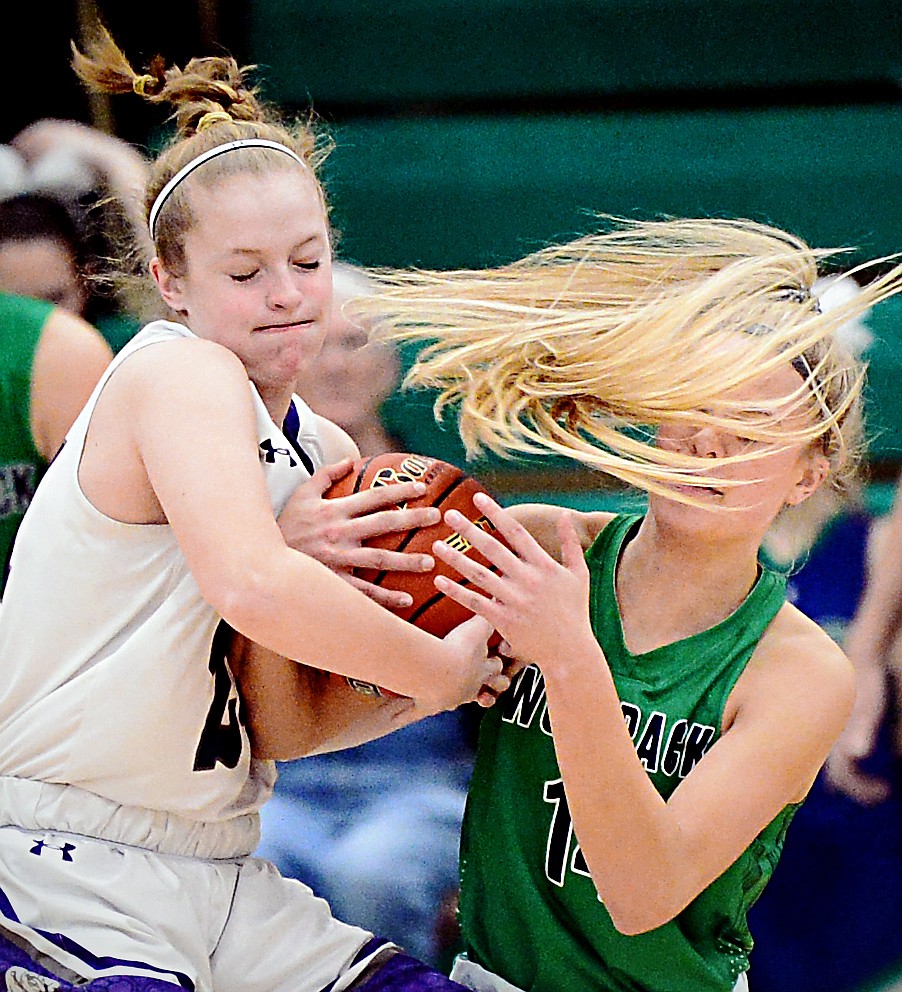 Glacier's Aubrie Rademacher (14) fights for a loose ball with Butte's Trisha Ericson (24) at Glacier High School on Saturday. (Casey Kreider/Daily Inter Lake)