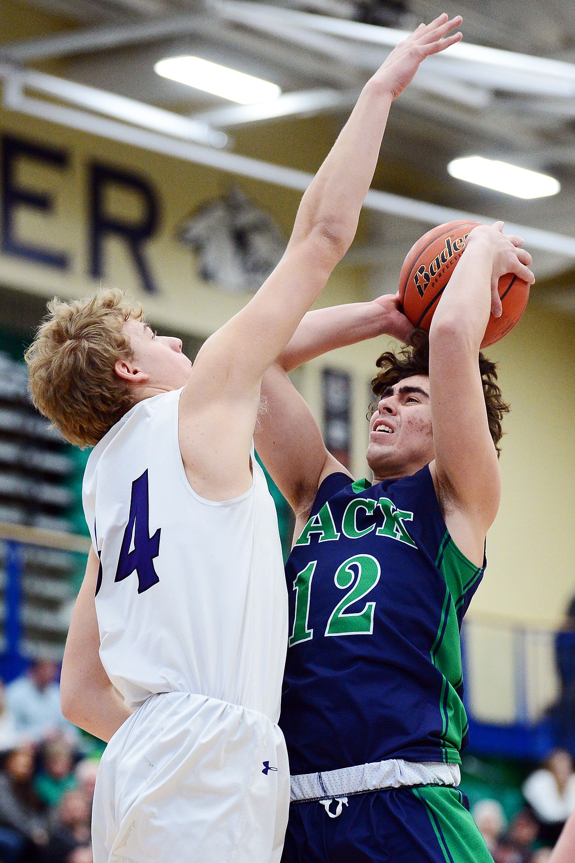 Glacier's Weston Price (12) drives to the hoop against Butte's Jake Olson (34) at Glacier High School on Saturday. (Casey Kreider/Daily Inter Lake)