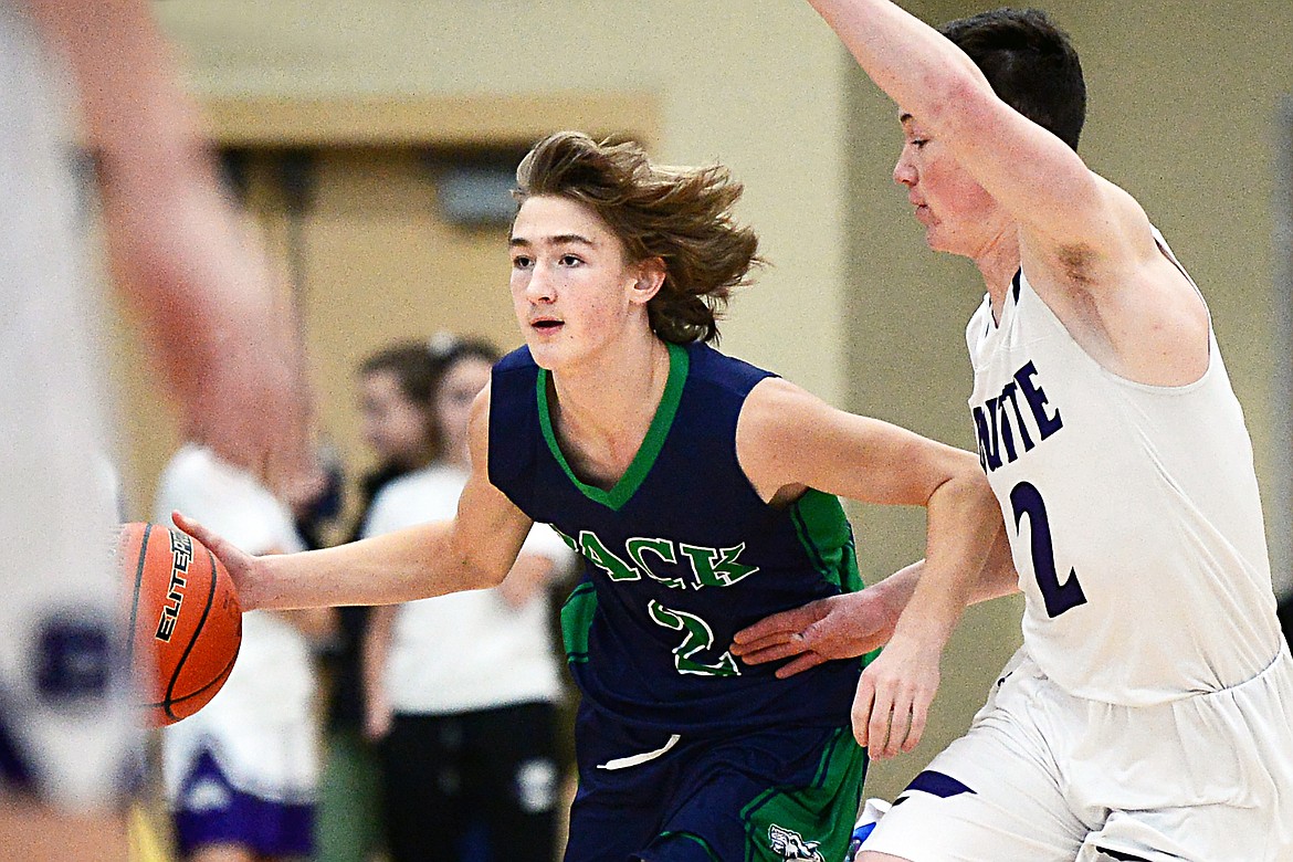 Glacier's Keifer Spohnhauer (2) brings the ball upcourt against Butte's Tommy Mellott (2) at Glacier High School on Saturday. (Casey Kreider/Daily Inter Lake)