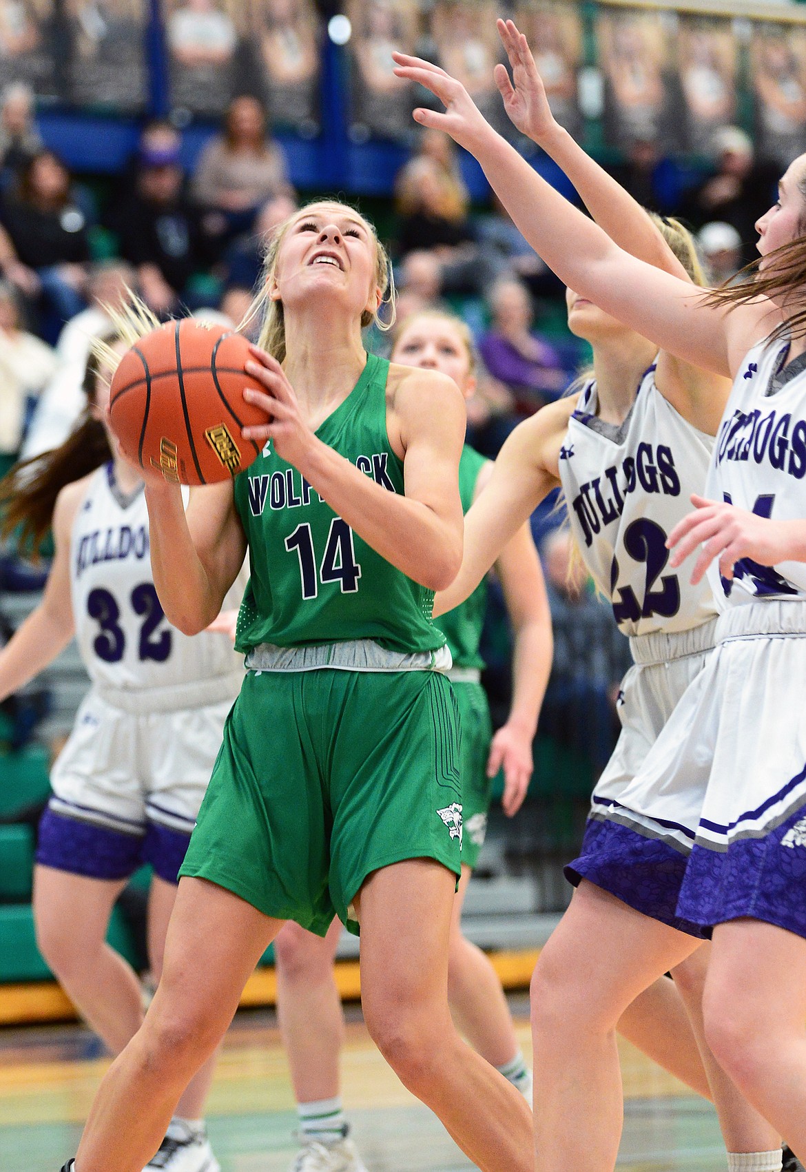 Glacier's Aubrie Rademacher (14) works for a shot under the basket against Butte at Glacier High School on Saturday. (Casey Kreider/Daily Inter Lake)