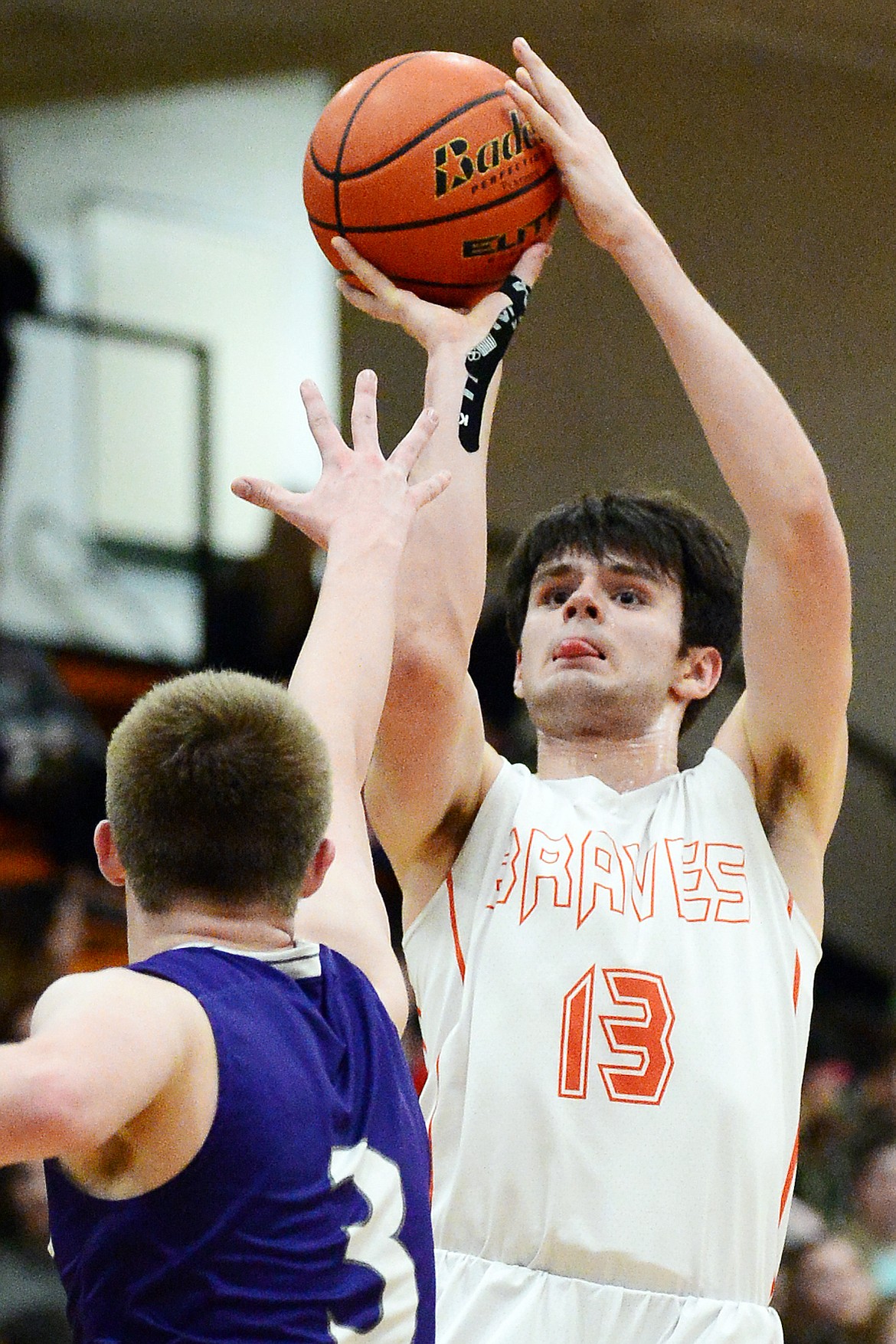 Flathead's Gabe Adams (13) looks to shoot over Butte's Cael Stenson (3) at Flathead High School on Friday. (Casey Kreider/Daily Inter Lake)