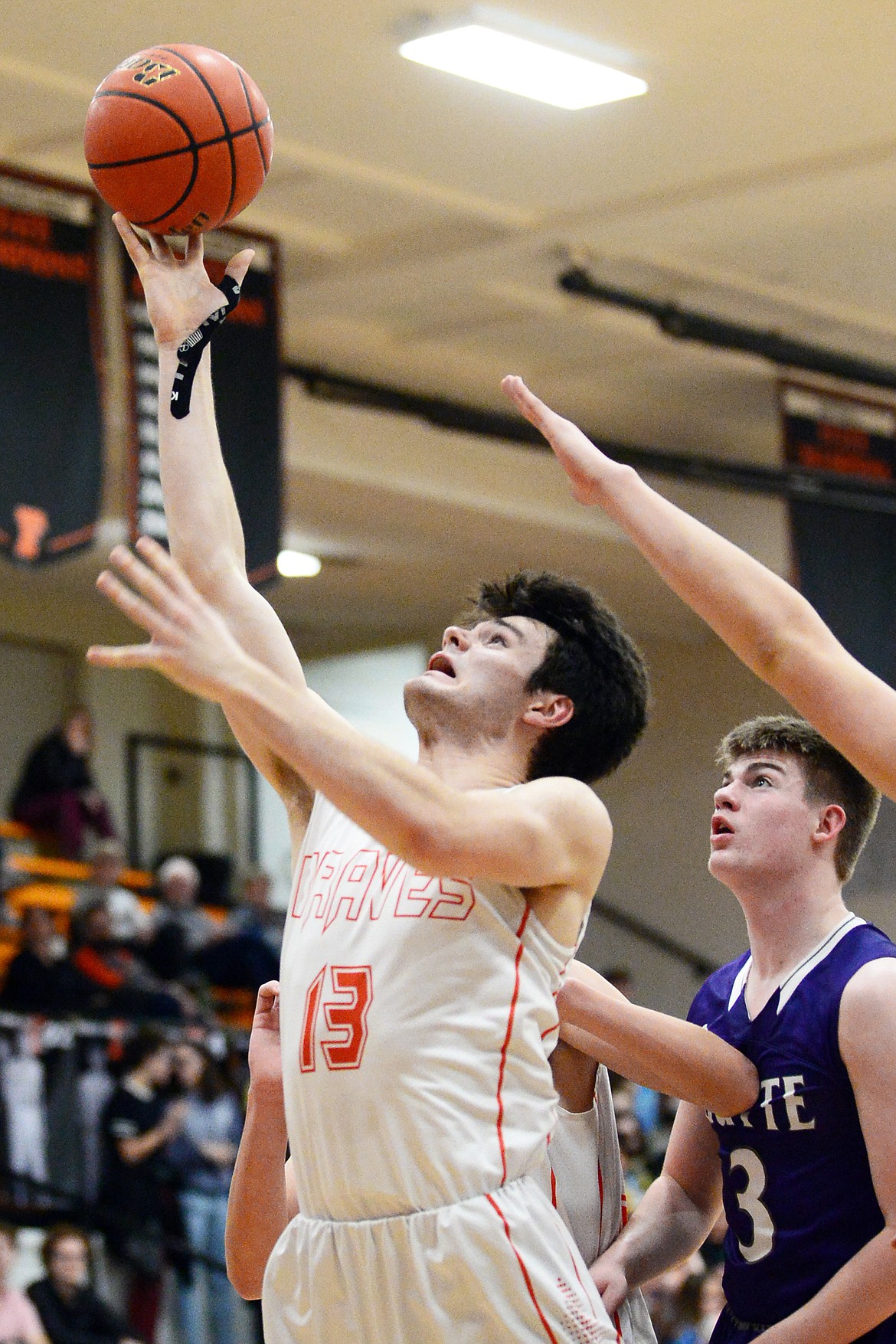 Flathead's Gabe Adams (13) drives to the basket against Butte at Flathead High School on Friday. (Casey Kreider/Daily Inter Lake)