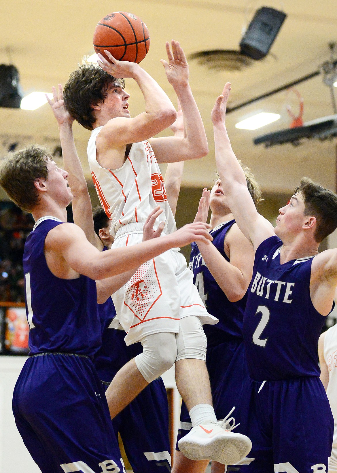 Flathead's Cooper Smith (20) sinks a bucket surrounded by Butte defenders in the fourth quarter at Flathead High School on Friday. (Casey Kreider/Daily Inter Lake)