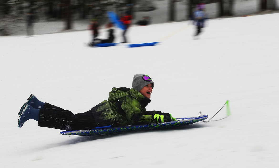 Kamden Kelly, 7, smiles big as he sleds down Cherry Hill on Monday after the weekend&#146;s snowstorm. Local area schools were closed yesterday due to weather and road conditions. (LOREN BENOIT/Press)