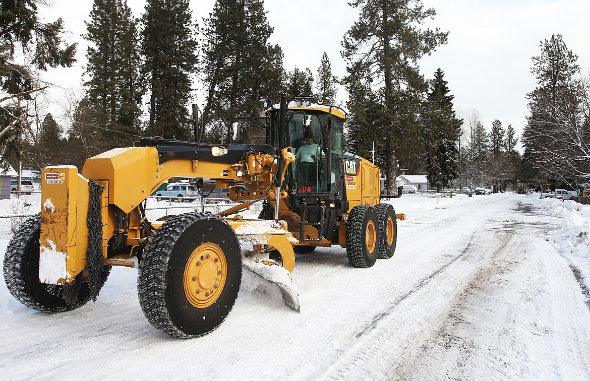 LOREN BENOIT/Press
A city of Coeur d&#146;Alene snowplow removes snow from the side of the road on Coeur d&#146;Alene Avenue Monday.