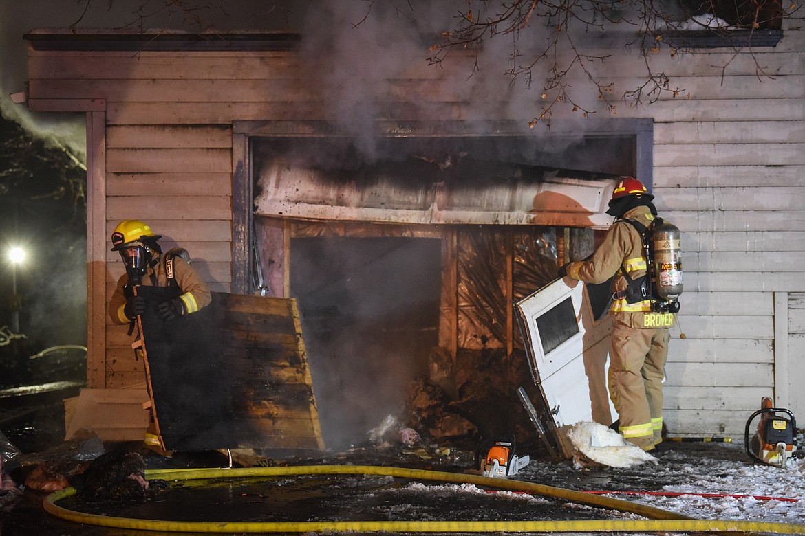 Firefighters work at the scene of a house fire in the 1200 block of 4th Avenue East in Kalispell on Wednesday night. (Casey Kreider/Daily Inter Lake)