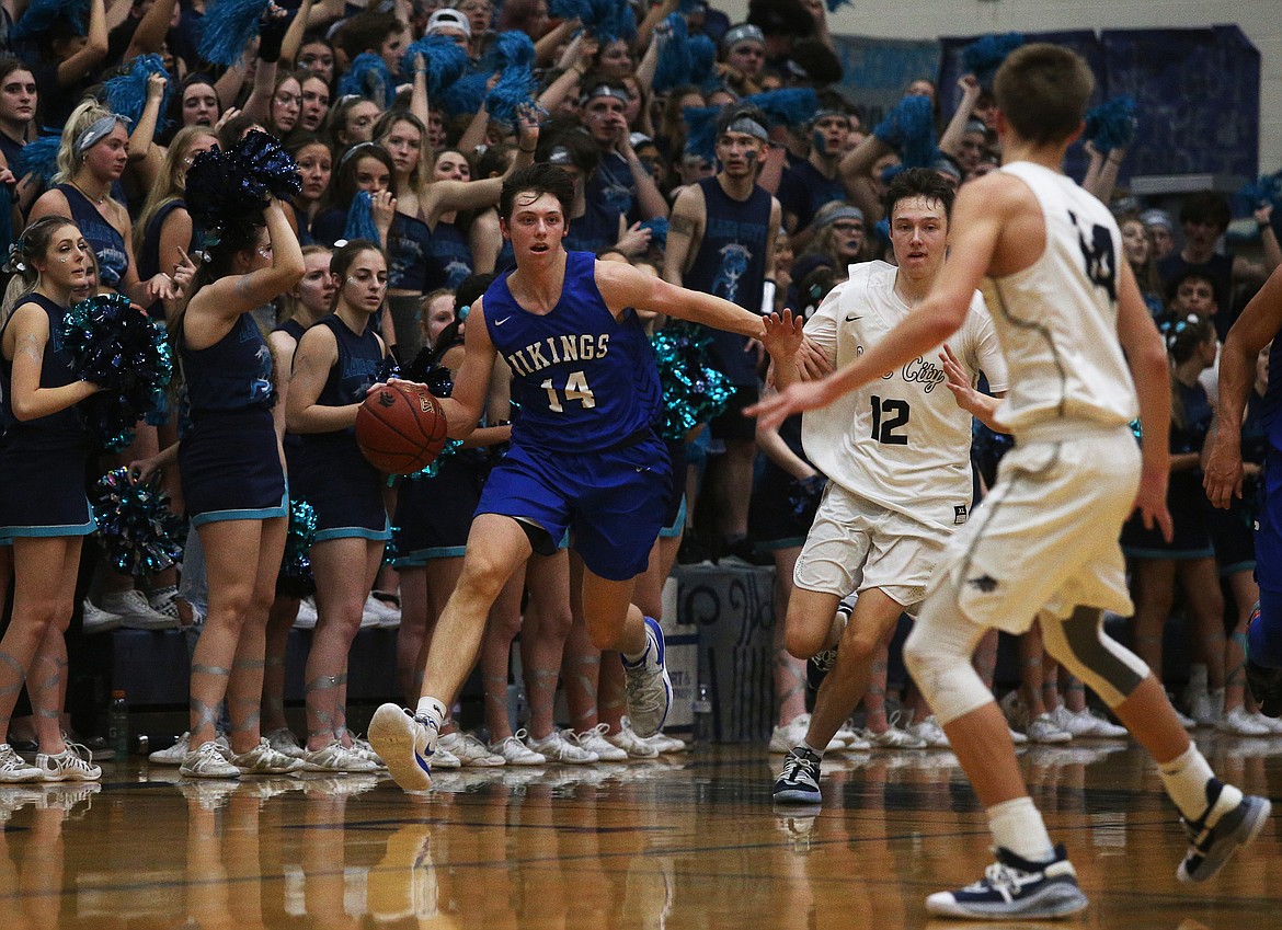 Coeur d&#146;Alene&#146;s Alex Karns dribbles the ball down the court while defended by Lake City&#146;s Seth Hanson (12) during Fight for the Fish.