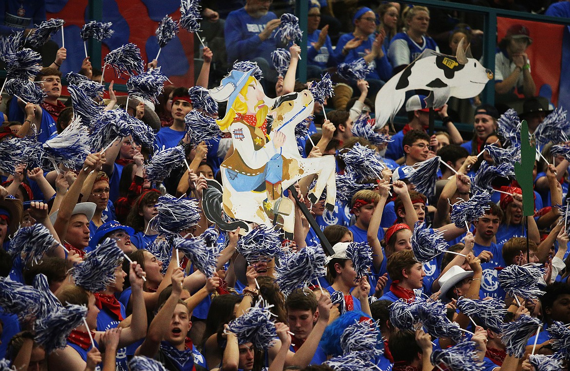 The Coeur d&#146;Alene High School student section passes around a viking cowboy cutout during Fight for the Fish on Friday at Lake City High.