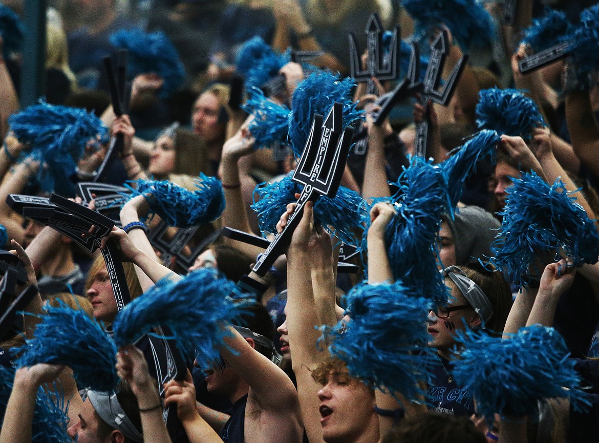 Lake City High School students raise their tridents during Fight for the Fish.