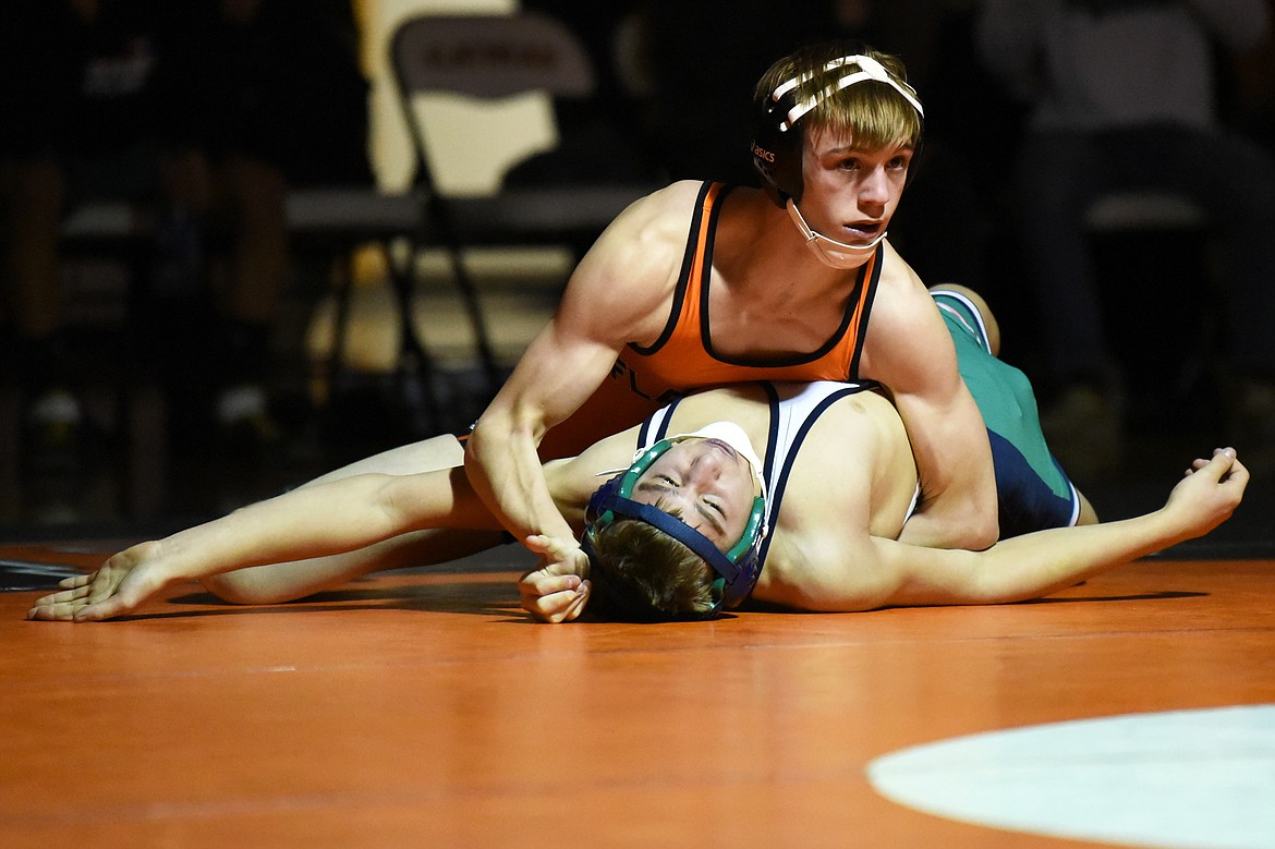 Flathead's Cade Troupe works toward a pin of Glacier's Hunter Magness at 126 lbs. at Flathead High School on Friday. (Casey Kreider/Daily Inter Lake)