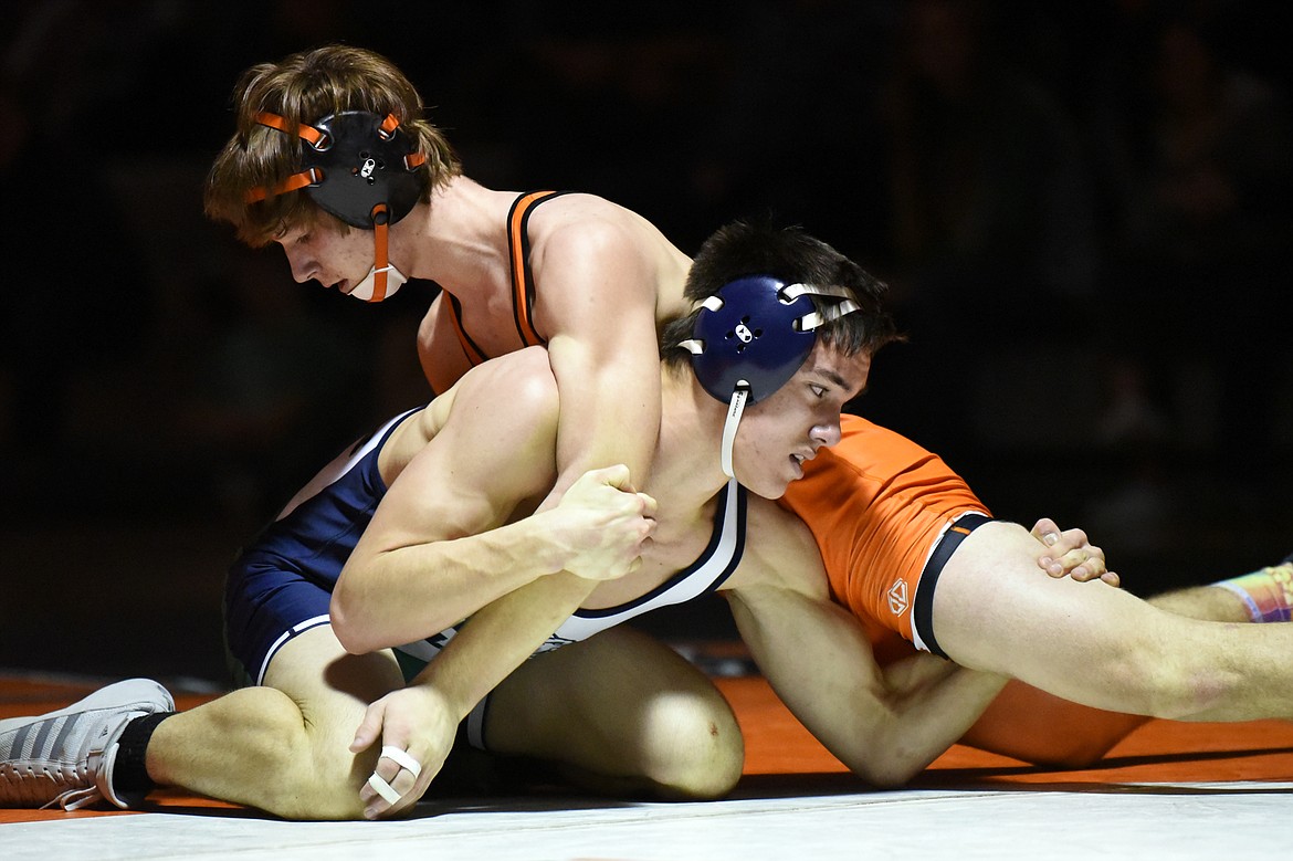 Glacier's Royce Conklin wrestles Flathead's Noah Poe-Hatten at 152 lbs. at Flathead High School on Friday. Poe-Hatten won by decision. (Casey Kreider/Daily Inter Lake)