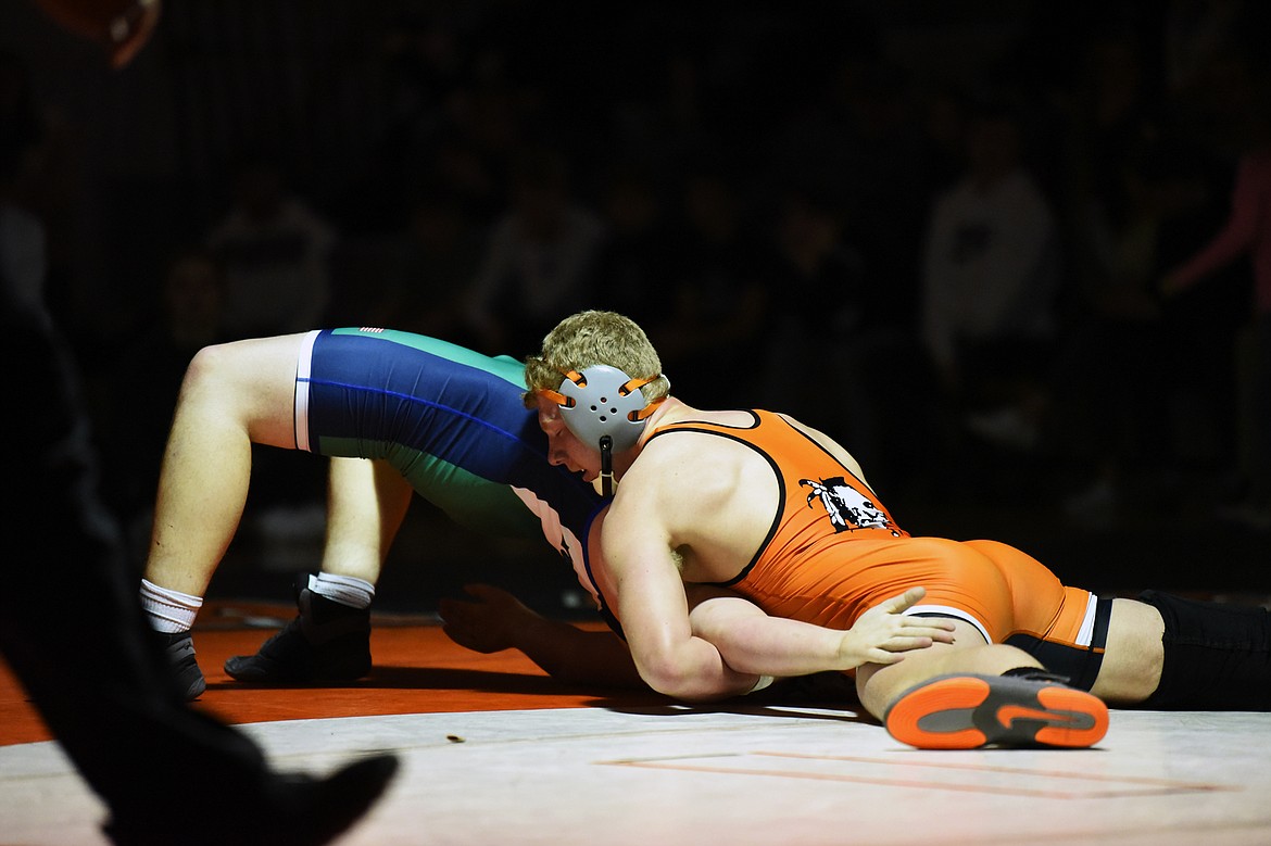 Flathead's Zaybin Stewart works toward a pin of Glacier's Caedon Seymour at 205 lbs. at Flathead High School on Friday. (Casey Kreider/Daily Inter Lake)