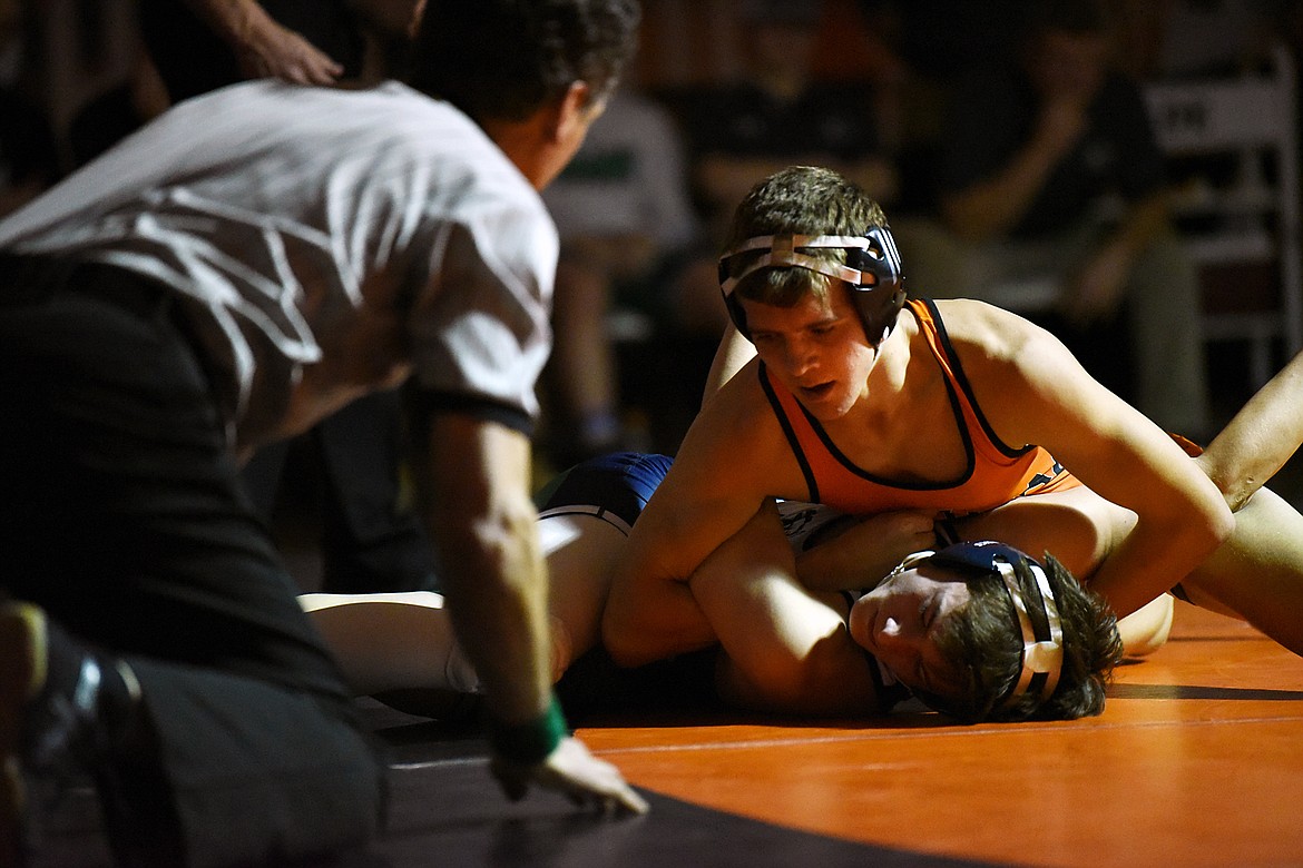 Flathead's Brendan Barnes works toward a pin of Glacier's Ricardo Hewitt at 138 lbs. at Flathead High School on Friday. (Casey Kreider/Daily Inter Lake)