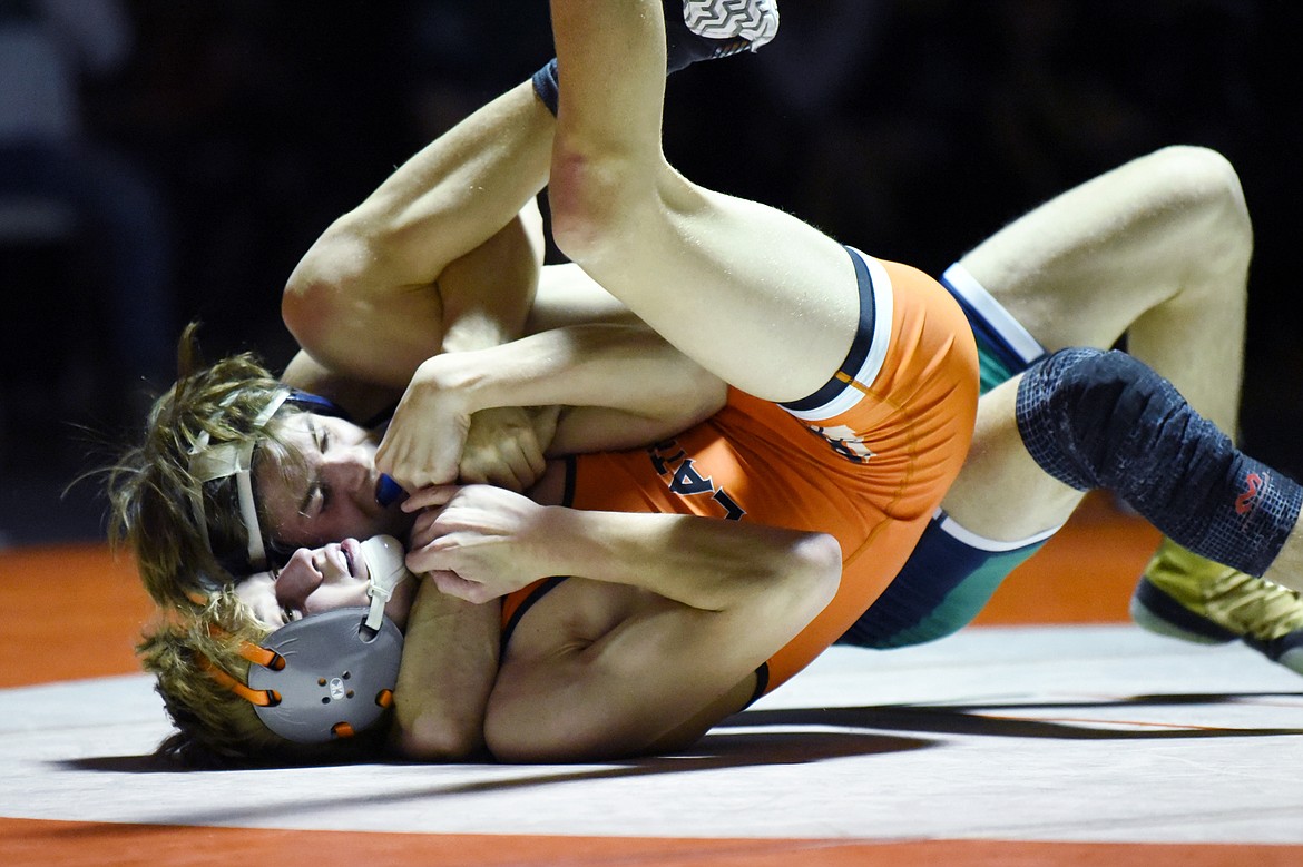 Glacier's Cody Frost works toward a pin of Flathead's Nolan Cate at 120 lbs. at Flathead High School on Friday. (Casey Kreider/Daily Inter Lake)