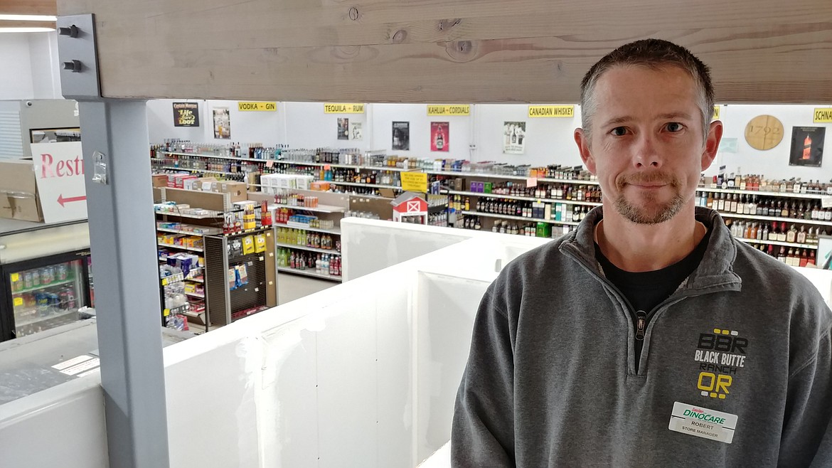 Robert Buss, store manager of Stangs in St. Regis, from outside his office overlooking the store. (Chuck Bandel/Mineral Independent)