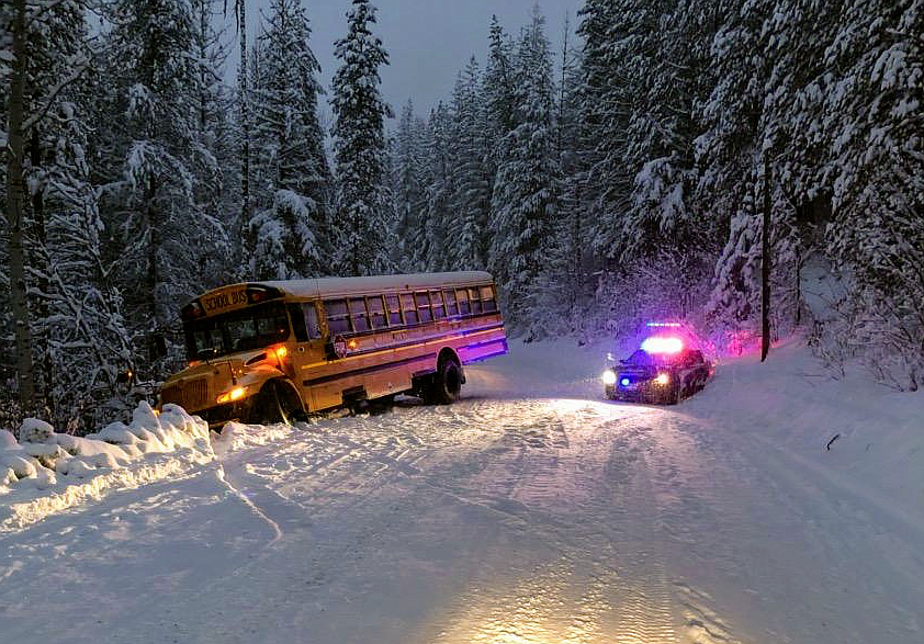 Courtesy photo
The affected school bus sits next to Osburn Police Chief Darell Bratten&#146;s patrol car, which also slid out due to the slick conditions.