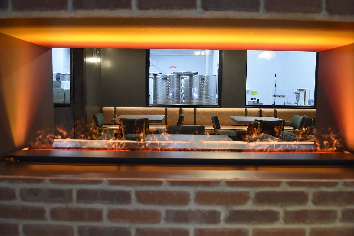 A water vapor fireplace inside Unleashed: A Winery provides a view into the production room adjacent to the tasting room. (Heidi Desch/Whitefish Pilot)