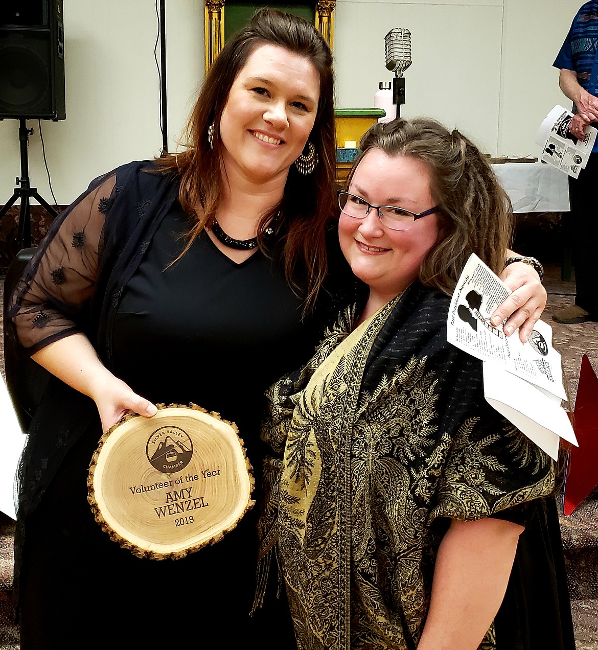 SVCC President Tara Lodi (left) presents the Silver Valley Chamber Volunteer of the Year award to Amy Wenzel.