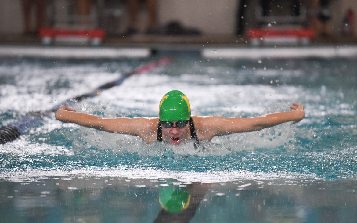 Jessica Henson comes up for air in the 100m butterfly during the Dog-Cat Invite on Saturday at The Wave. (Daniel McKay/Whitefish Pilot)