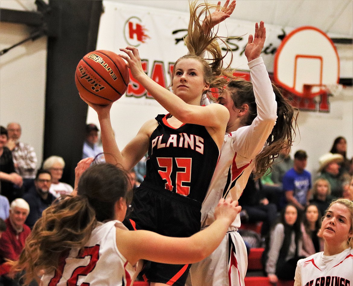 KIMMY CURRY (32) jumping for a layup, with a straight face, to score for Plains, last Friday. (John Dowd/Clark Fork Valley Press)