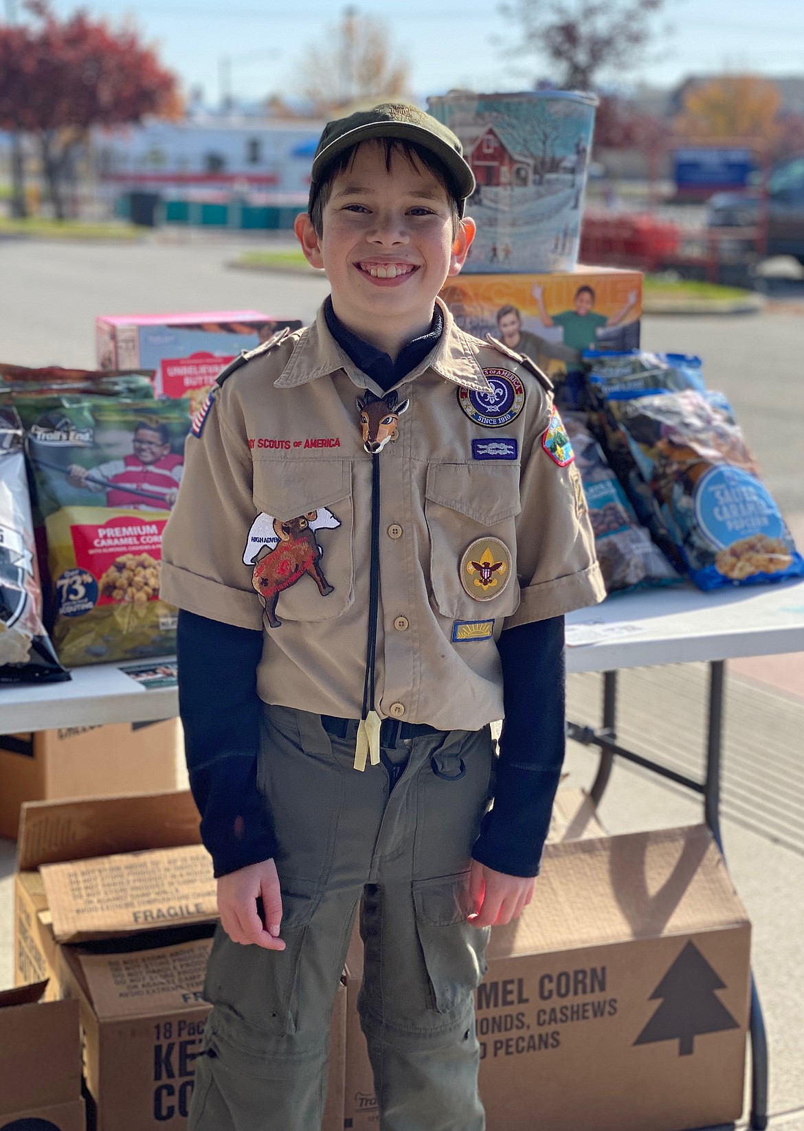 Courtesy photo
Logan Fisher, 12, of Post Falls, beams a smile by his popcorn stand during the Inland Northwest Council Popcorn Sale last fall. Logan brought in $15,000 and spent $1,200 of his earnings on Christmas decorations for a local senior living facility that he and his family decorated on Thanskgiving night.