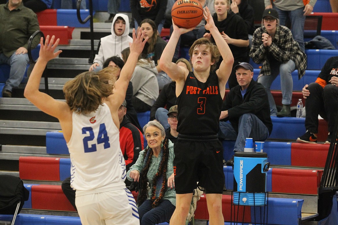 Caden McLean of Post Falls hits the go-ahead 3-pointer with just over 1 minute left Thursday night at Viking Court, as Jack Prka of Coeur d&#146;Alene defends.

MARK NELKE/Press