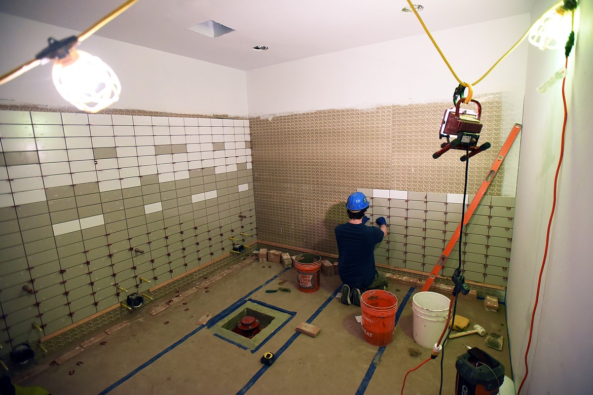 Cameron Morris, with CLM Tile &amp; Stone in Whitefish, installs tile in bathrooms at the new Somers Middle School building on Wednesday, Jan. 22. (Casey Kreider/Daily Inter Lake)