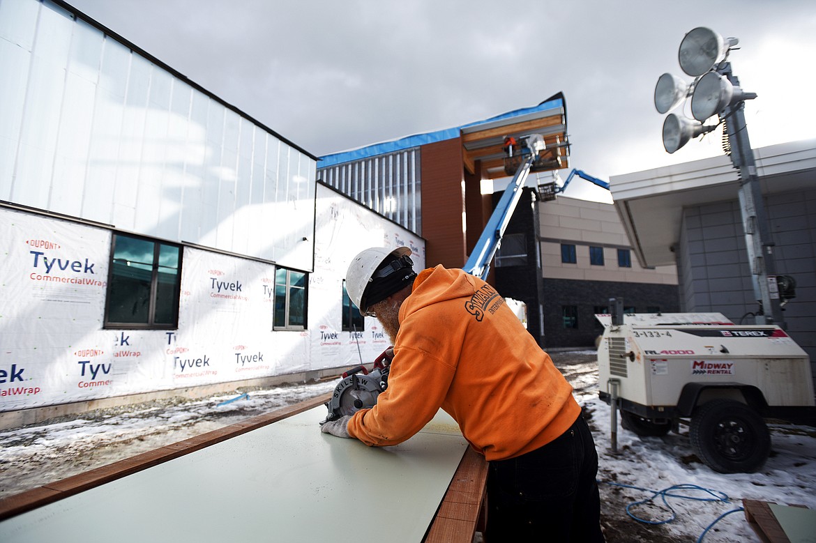 Gary Hawkinson, with Swank Enterprises, cuts composite panels for the exterior of Somers Middle School on Wednesday, Jan. 22. (Casey Kreider/Daily Inter Lake)