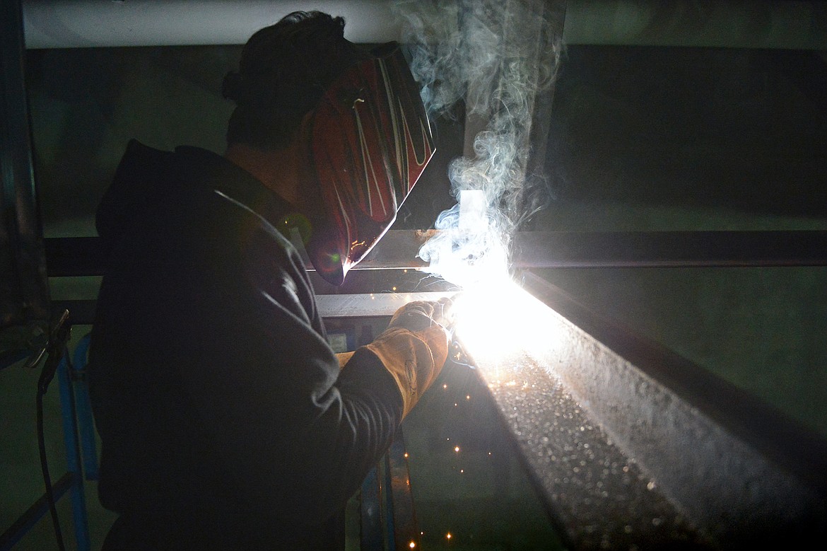 Duke Goss, superintendant with Swank Enterprises, welds a beam in the ceiling of the future gymnasium at Somers Middle School on Wednesday, Jan. 22. (Casey Kreider/Daily Inter Lake)