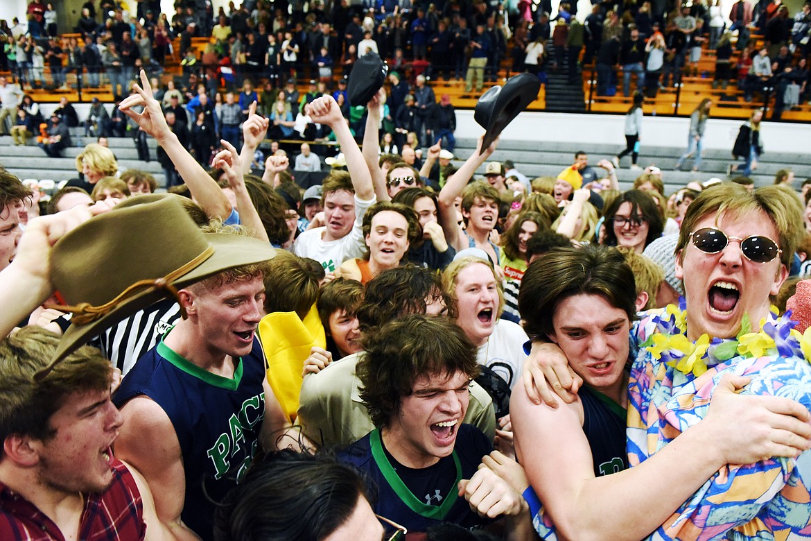 Glacier's student section spills out onto the court to celebrate with the Wolfpack after their 45-40 win over Flathead during a crosstown matchup at Flathead High School on Friday. (Casey Kreider/Daily Inter Lake)