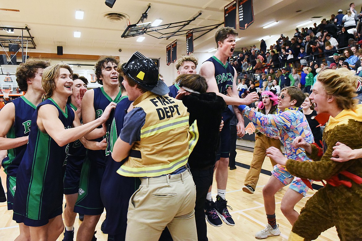 Glacier's student section spills out onto the court to celebrate with the Wolfpack after their 45-40 win over Flathead during a crosstown matchup at Flathead High School on Friday. (Casey Kreider/Daily Inter Lake)