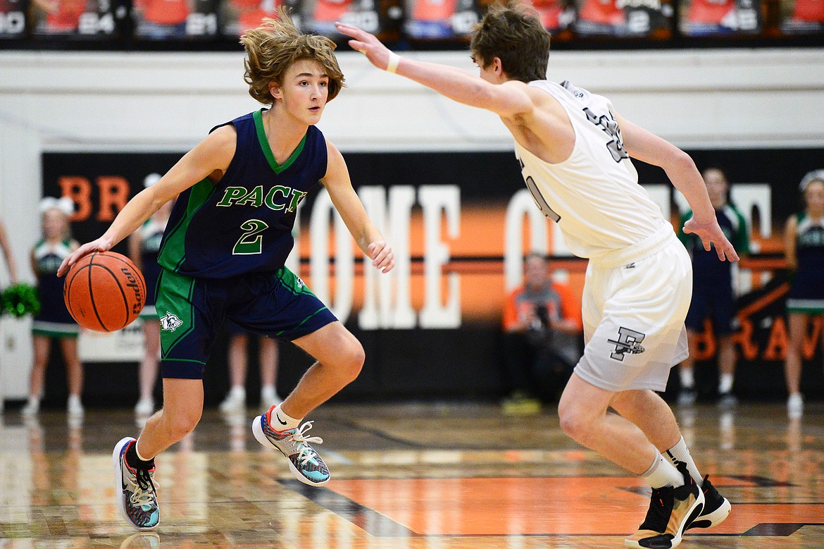 Glacier's Keifer Spohnhauer (2) controls the ball at the top of the key guarded by Flathead's Joston Cripe (34) during a crosstown matchup at Flathead High School on Friday. (Casey Kreider/Daily Inter Lake)