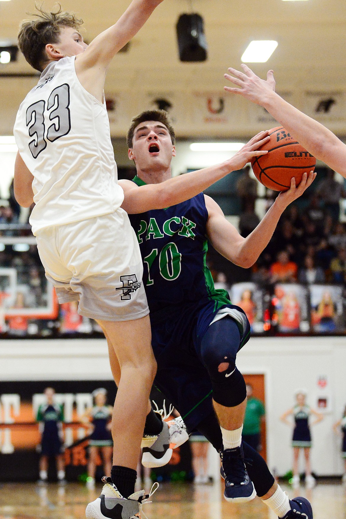 Glacier's KJ Johnson (10) drives to the basket guarded by Flathead's Ezra Epperly (33) in the first half during a crosstown matchup at Flathead High School on Friday. (Casey Kreider/Daily Inter Lake)