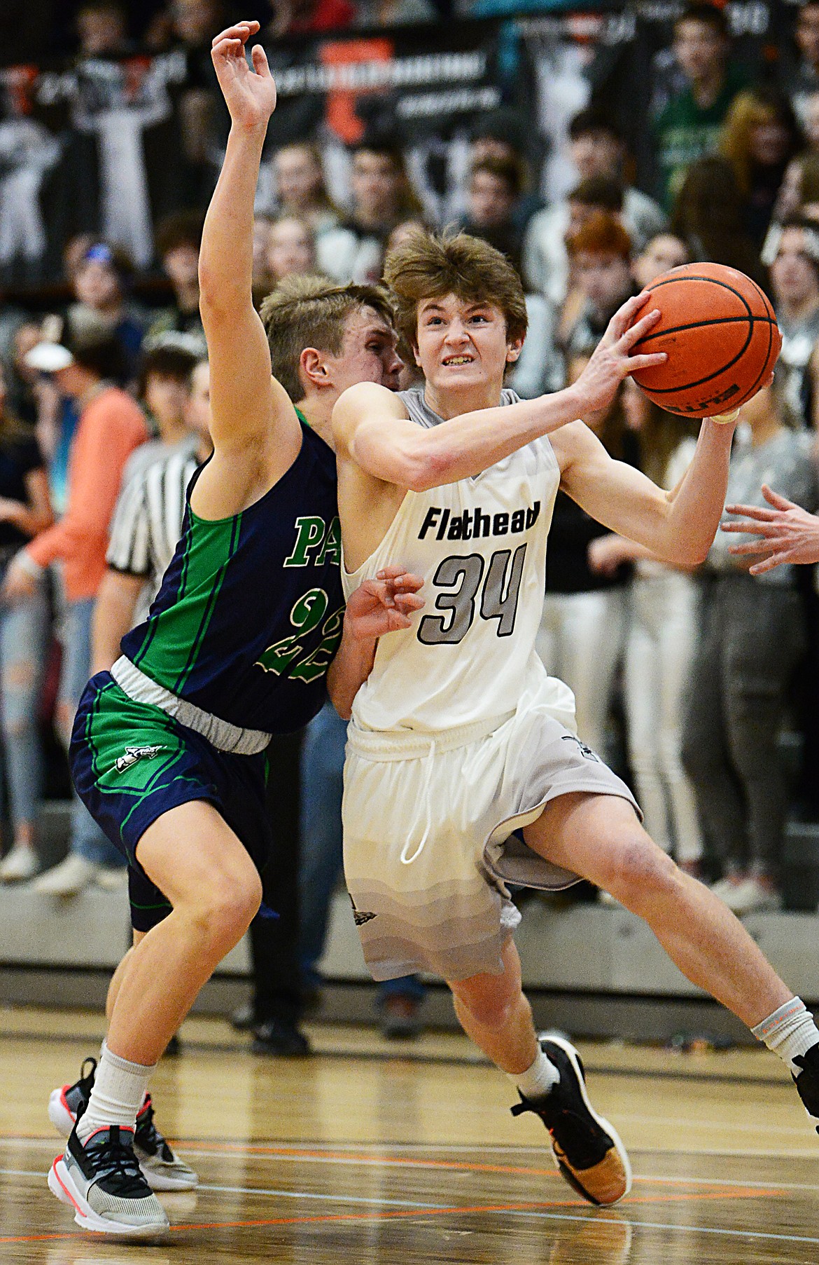 Flathead's Joston Cripe (34) drives to the basket past Glacier's Michael Schwarz (22) in the second half during a crosstown matchup at Flathead High School on Friday. (Casey Kreider/Daily Inter Lake)