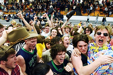 Glaciers student section spills out onto the court to celebrate with the Wolfpack after their 45-40 win over Flathead during a crosstown matchup at Flathead High School on Friday. (Casey Kreider/Daily Inter Lake)