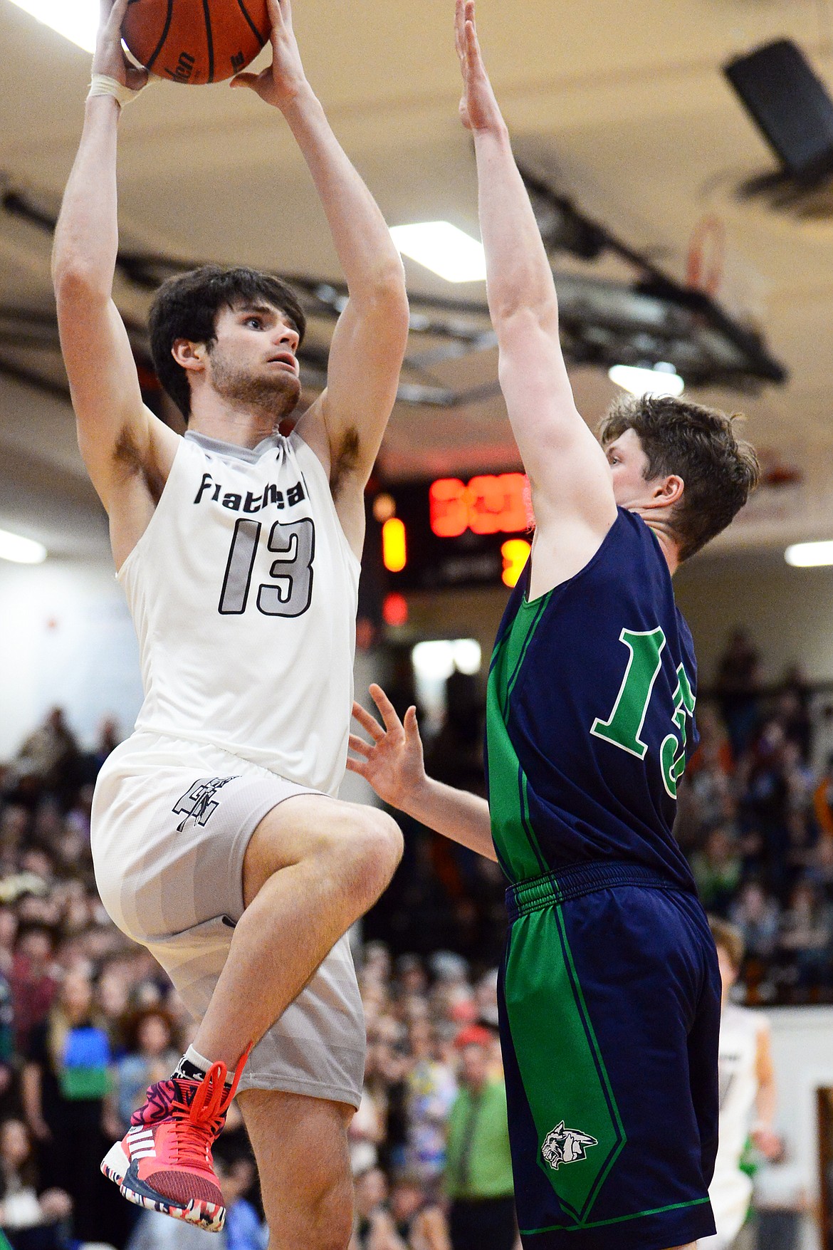 Flathead&#146;s Gabe Adams (13) drives to the basket guarded by Glacier&#146;s Drew Engellant (15) during a crosstown matchup at Flathead High School on Friday. (Casey Kreider/Daily Inter Lake)