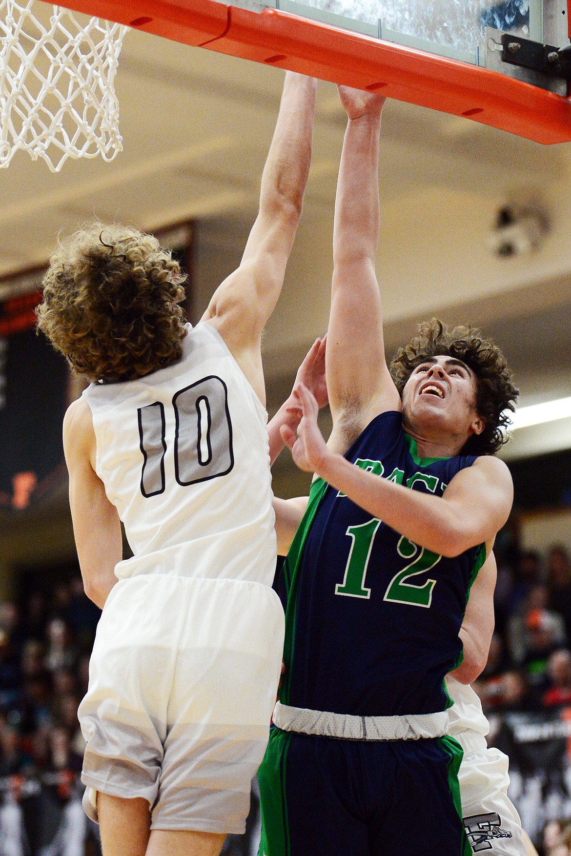 Glacier&#146;s Weston Price (12) is met at the basket by Flathead&#146;s Hunter Hickey (10) in the first half during a crosstown matchup at Flathead High School on Friday. (Casey Kreider/Daily Inter Lake)