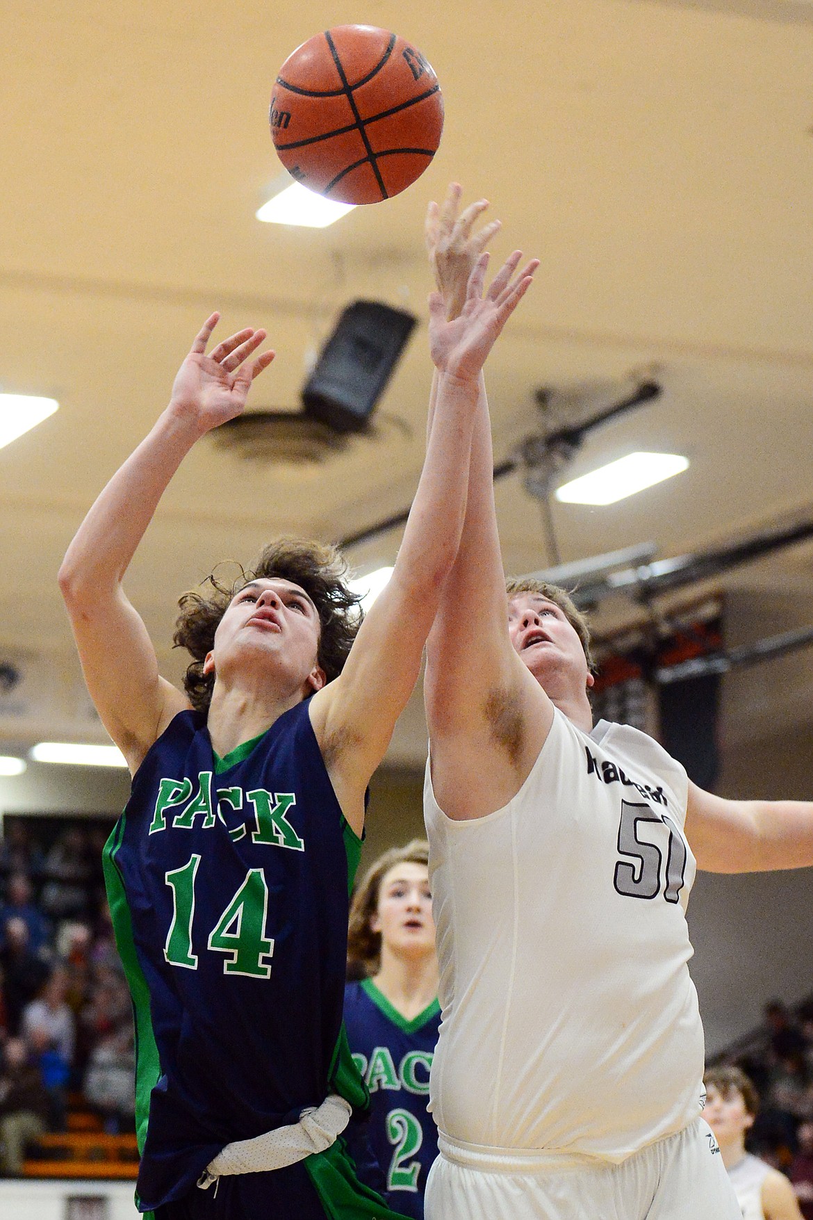 Glacier&#146;s Jaxson Olsen (14) and Flathead&#146;s Max Anderson (52) battle for a rebound in the second half during a crosstown matchup at Flathead High School on Friday. (Casey Kreider/Daily Inter Lake)