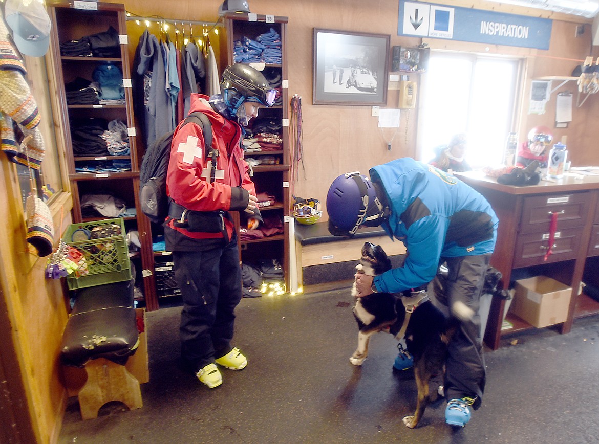 Bill Cubbage, director of snow sports at Whitefish Mountain Resort, pets one of the resort&#146;s trained avalanche dogs, inside the ski patrol office at the summit of Big Mountain.