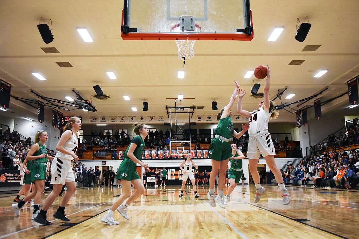 Flathead's Molly Winters (34) and Glacier's Janessa Henson (23) battle for a ball under the basket during a crosstown matchup at Flathead High School on Thursday. Glacier won, 51-49. (Casey Kreider/Daily Inter Lake)