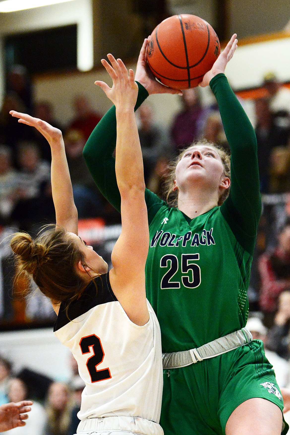 Glacier&#146;s Emma Anderson (25) goes to the hoop over Flathead&#146;s Emily Lembke (2) in the first half of a crosstown matchup at Flathead High School on Thursday. (Casey Kreider/Daily Inter Lake)