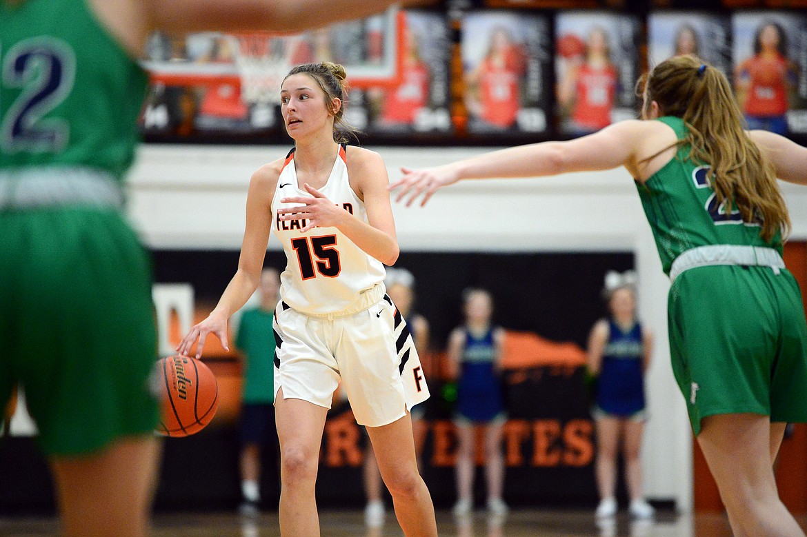 Flathead's Clare Converse (15) looks to the bench as she brings the ball upcourt during a crosstown matchup against Glacier at Flathead High School on Thursday. (Casey Kreider/Daily Inter Lake)